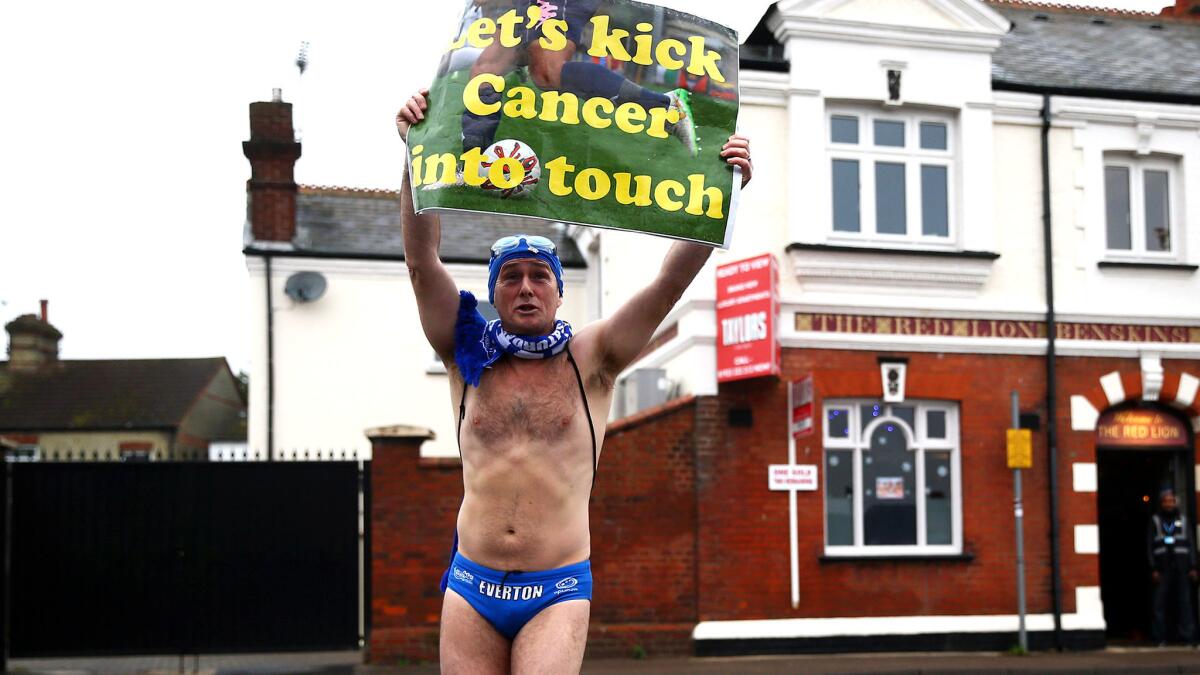 Everton fan Michael Cullen, also known as Speedo Mick, collects donations outside the stadium before a Premier League match against Watford.