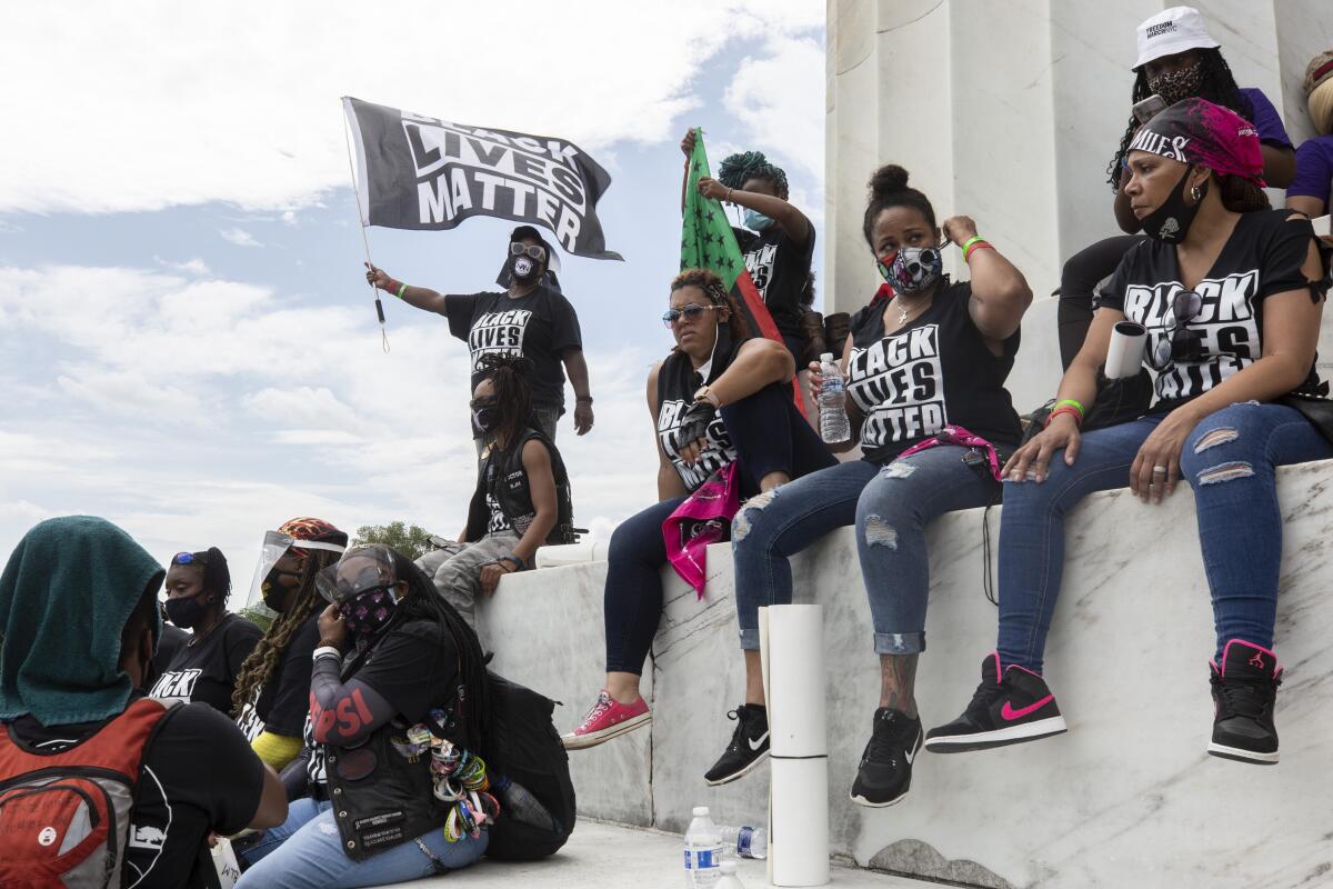 Demonstrators sit on the steps of the Lincoln Memorial listen to speakers before marching to the M.L.K. Memorial.