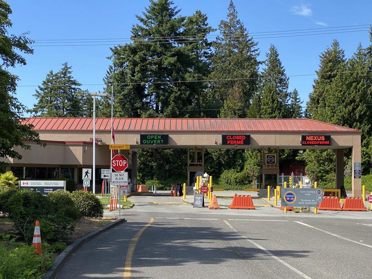 A single lane is open and empty at a border crossing.