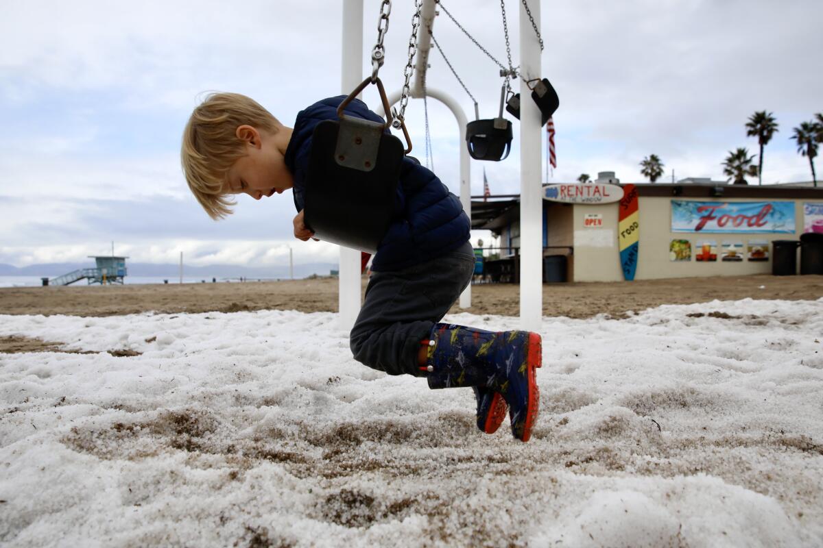 Graham Johnson, 3, from Manhattan Beach, came down to the beach to see the piles of snow 