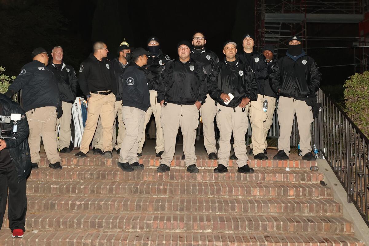Security personnel stand atop steps at UCLA.