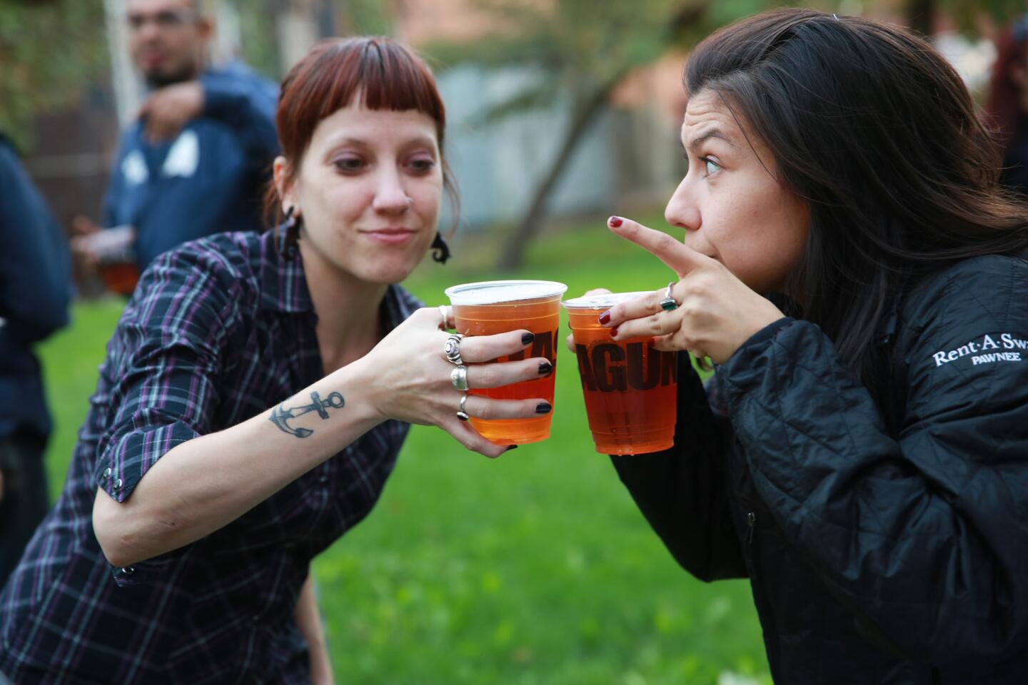 K.L. Kenzie, left, and Maegen Cadena toast each other as the Lagunitas Brewing Company prepared a Happy Hour gathering on Oct. 11. Brewing company officials worry that the shutdown may delay its seasonal beers.