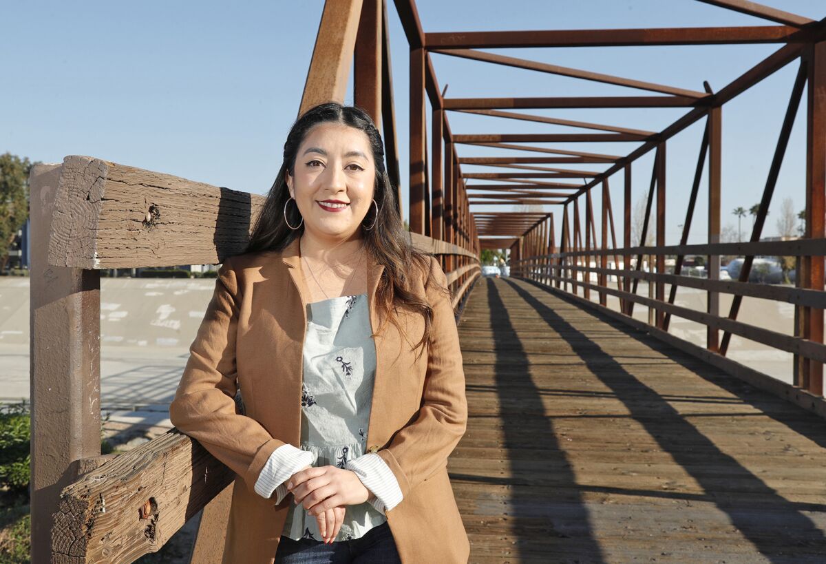 Kim Nguyen, of Garden Grove, stands next to the Edna Park bridge in Santa Ana.