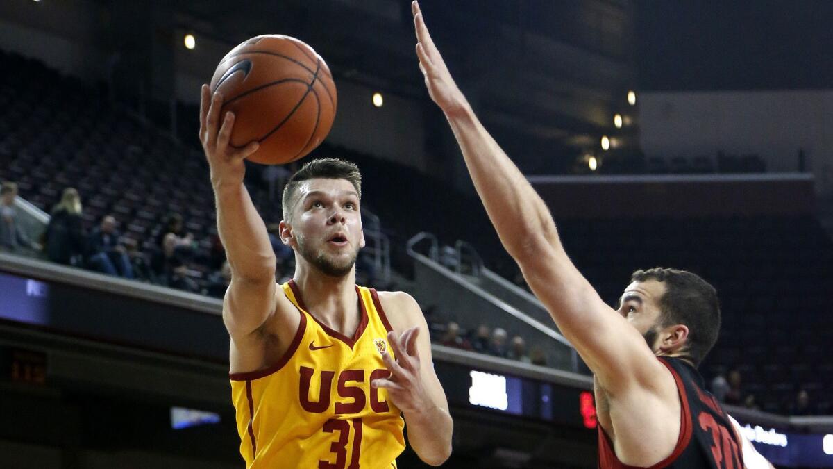 USC center Nick Rakocevic drives to the basket against Stanford's Josh Sharma during the first half Sunday.
