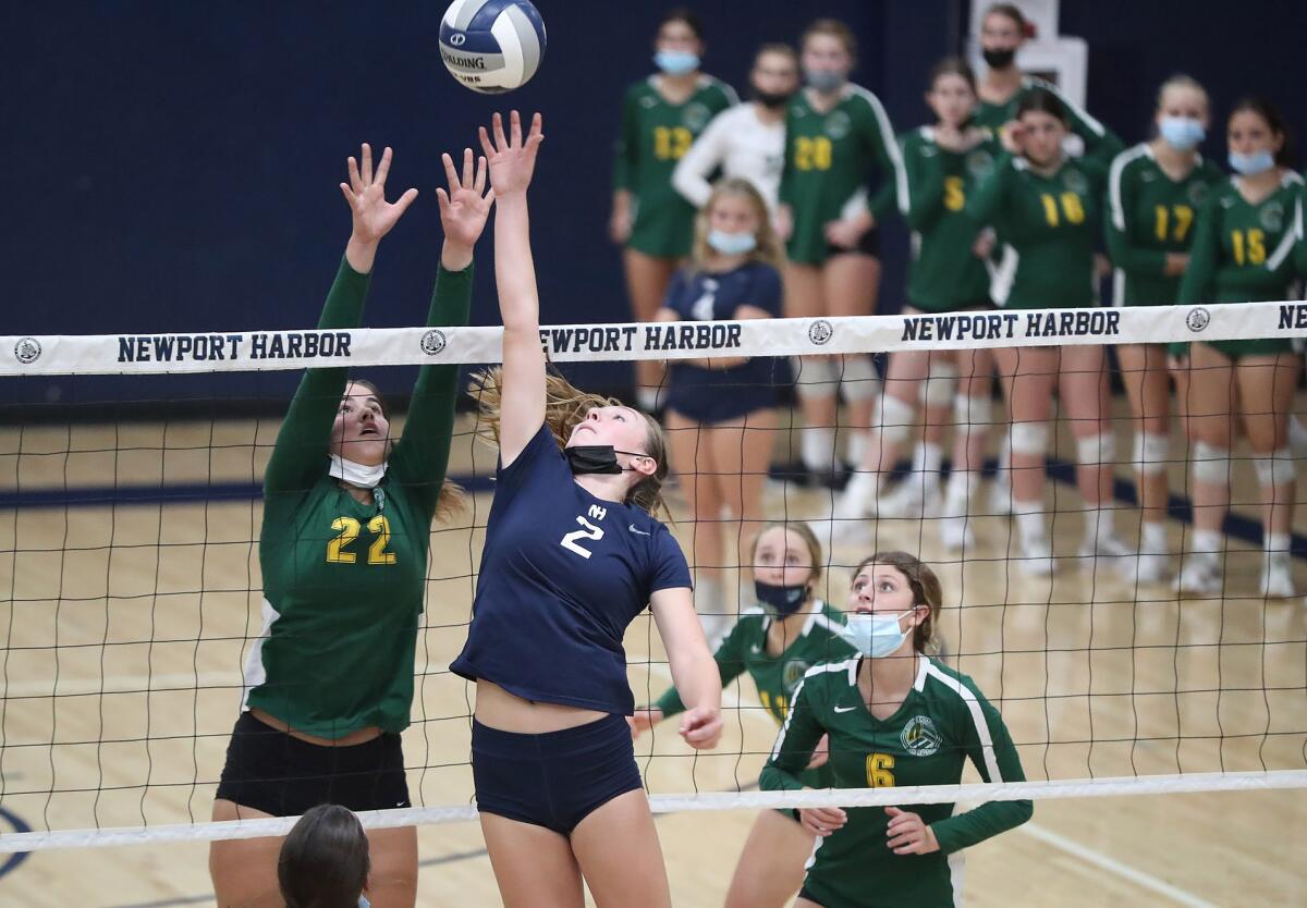 Newport Harbor's Kate Bland (2) tips the ball over Edison's Natalia Brandlin (22) during the Wave League title match.
