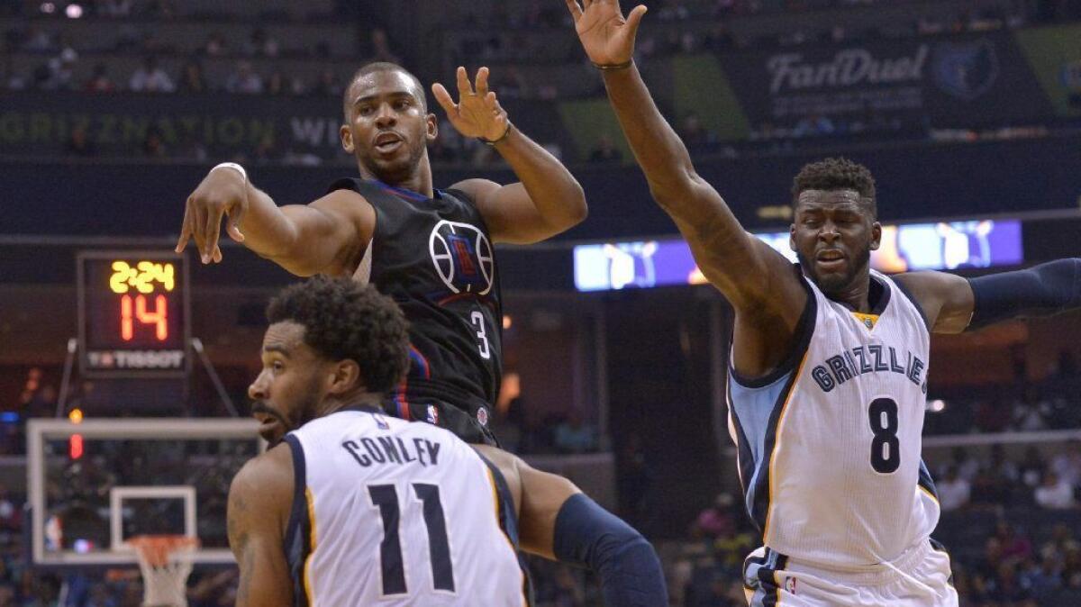 Clippers guard Chris Paul (3) passes past Grizzlies guard Mike Conley (11) and forward James Ennis (8) during the second half of a game on Nov. 4.