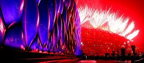 Fireworks light the sky over the National Aquatics Center and the National Stadium during the opening ceremony for the Beijing Summer Olympics.