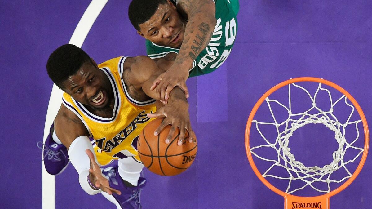 Lakers guard David Nwaba and Celtics guard Marcus Smart reach for a rebound during the second half Friday night.
