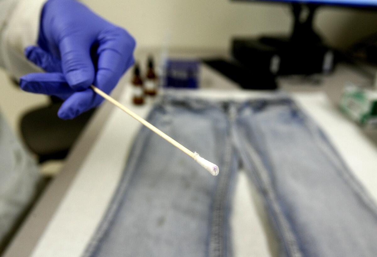 In this April 2012 photo, forensic DNA Supervisor Lisa Brewer holds a cotton swab that she tested for blood evidence on blue jeans at the opening of the Verdugo Regional Crime Laboratory in the Glendale Police Department. After a year of fundraising, a local nonprofit has donated $250,000 to fund operations at the crime lab.