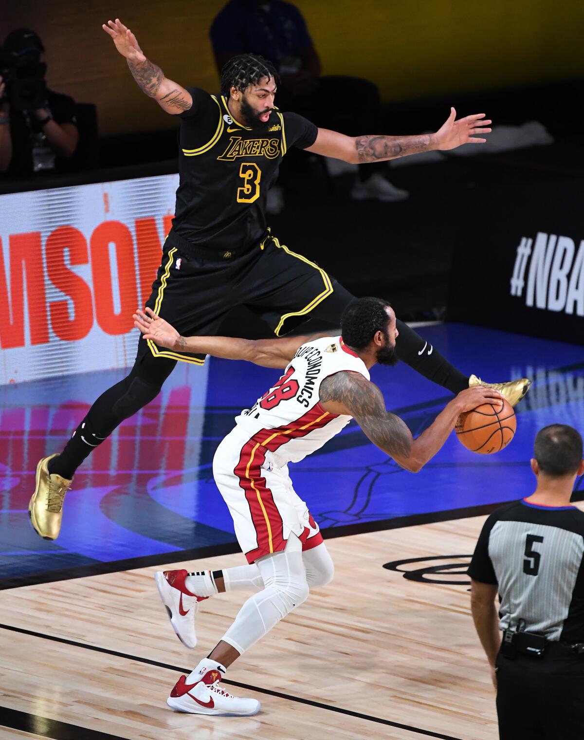 Lakers star Anthony Davis tries to defend Heat forward Andre Iguodala in Game 5 of the NBA Finals on Oct. 9 in Orlando, Fla.
