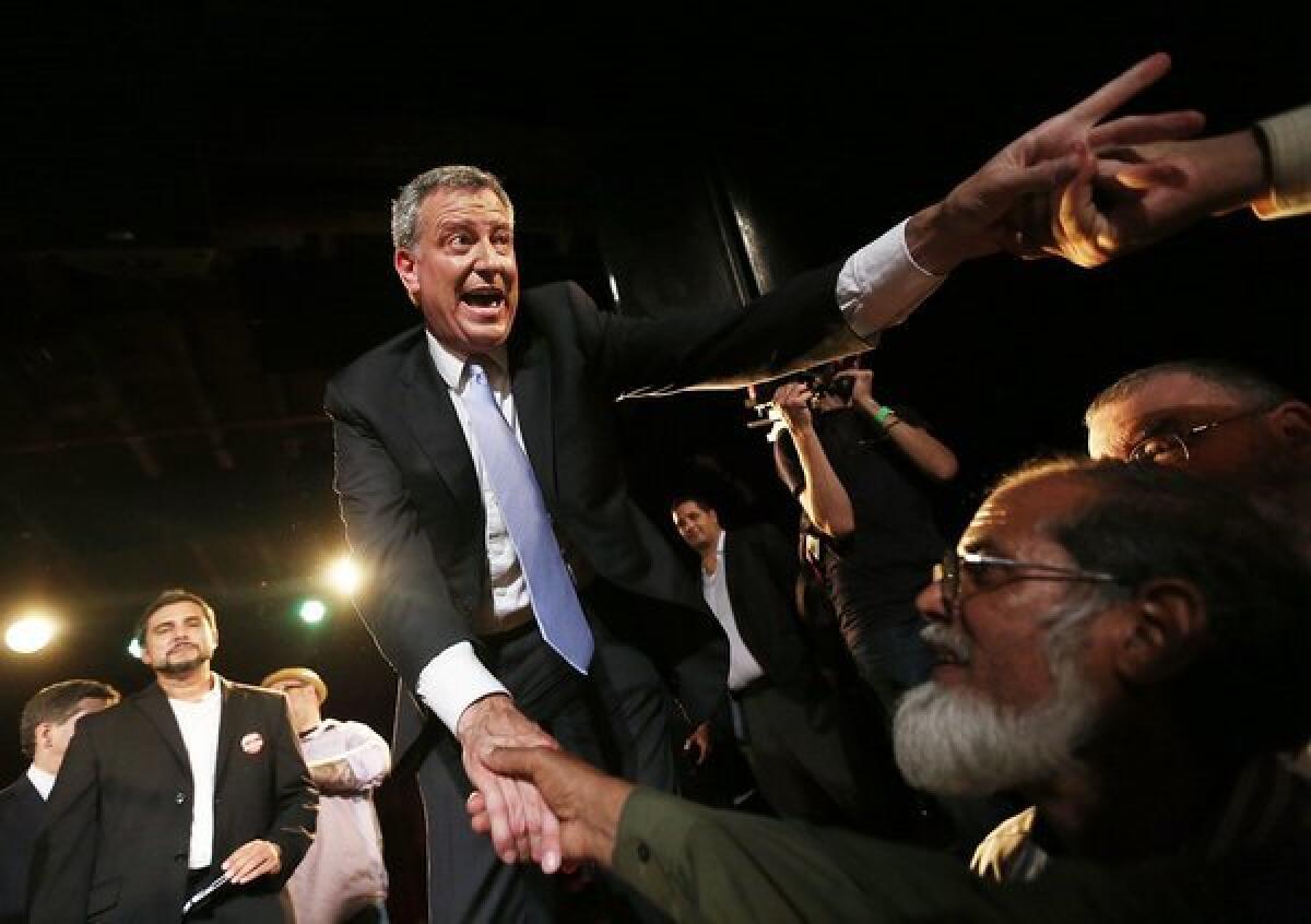 Bill de Blasio, winner of New York's Democratic mayoral primary, greets well-wishers at his victory party in Brooklyn.