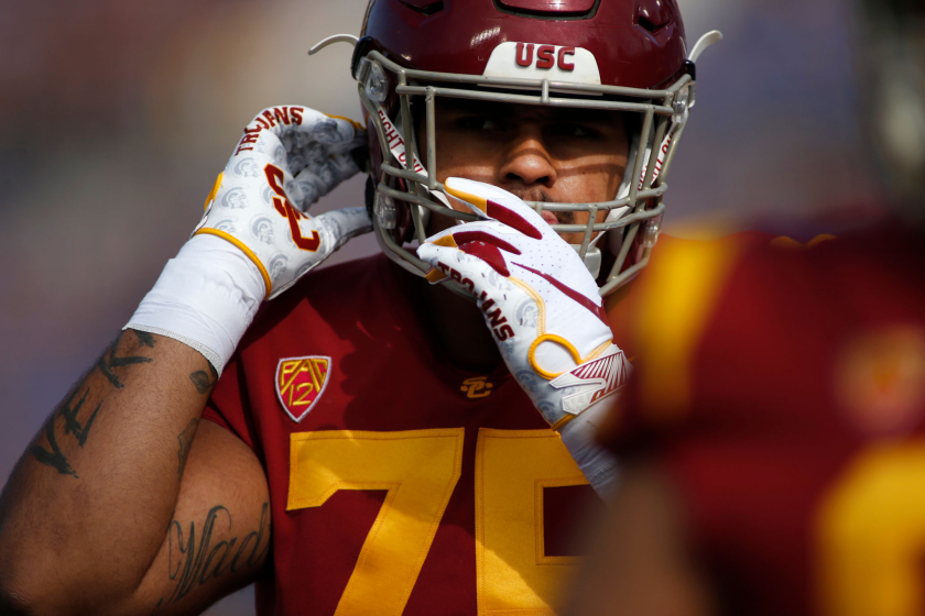 PASADENA, CALIFORNIA - NOVEMBER 17: Guard Alijah Vera-Tucker #75 of the USC Trojans adjusts his helmet.