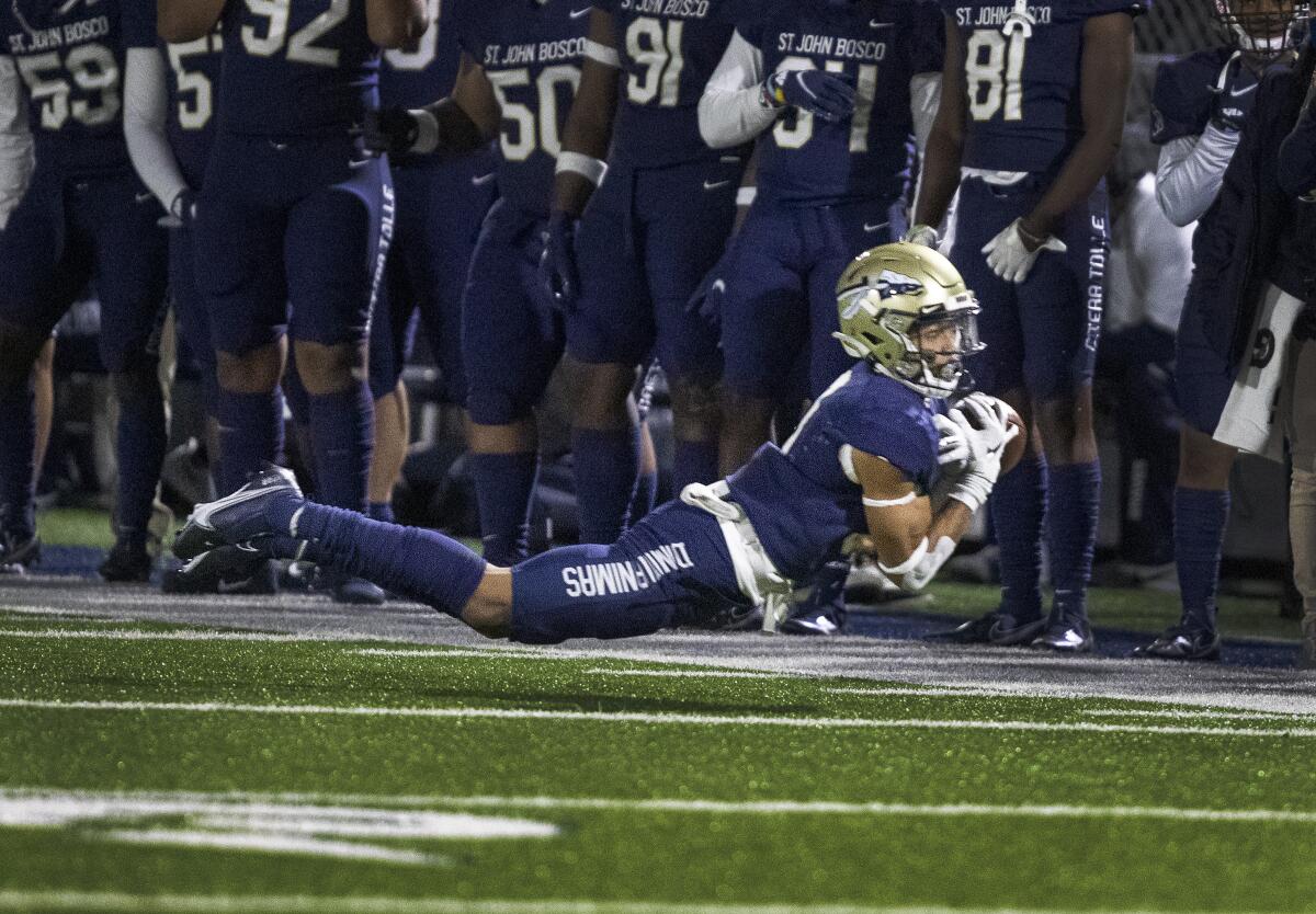 A St. John Bosco player tries to make a diving catch.