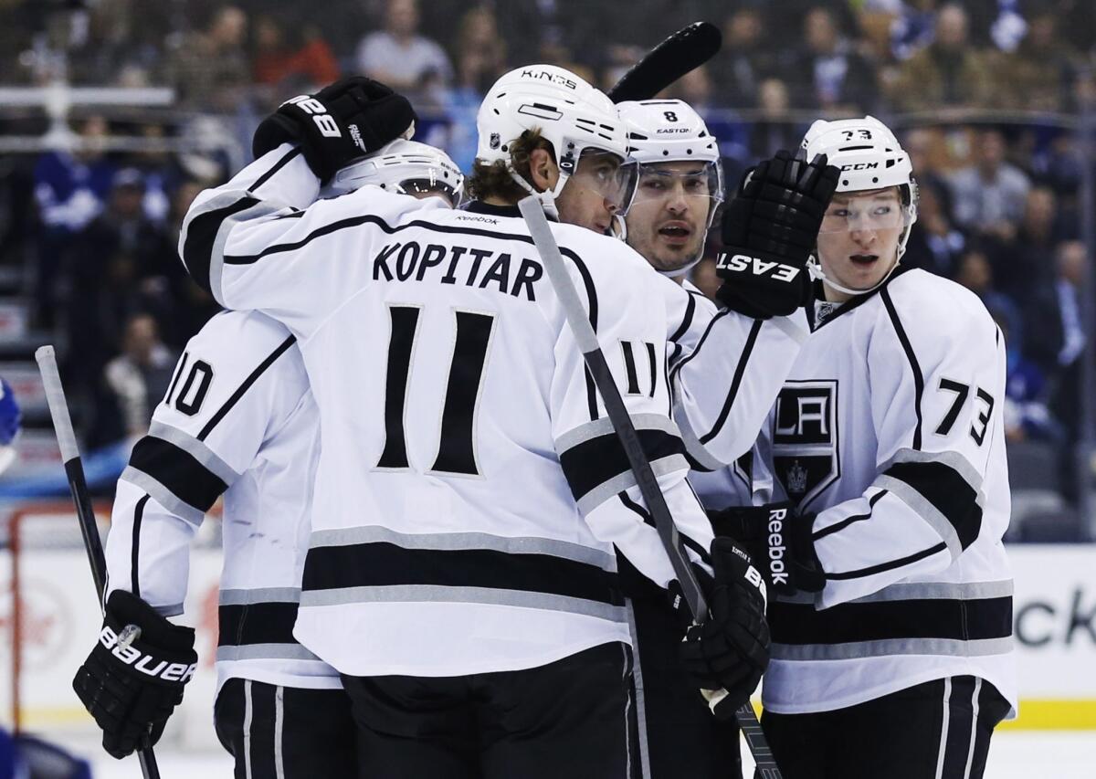 Kings defenseman Drew Doughty, second from right, is congratulated by teammates Mike Richards, left, Anze Kopitar and Tyler Toffoli after scoring during the first period of the Kings' 3-1 win over the Toronto Maple Leafs on Wednesday.