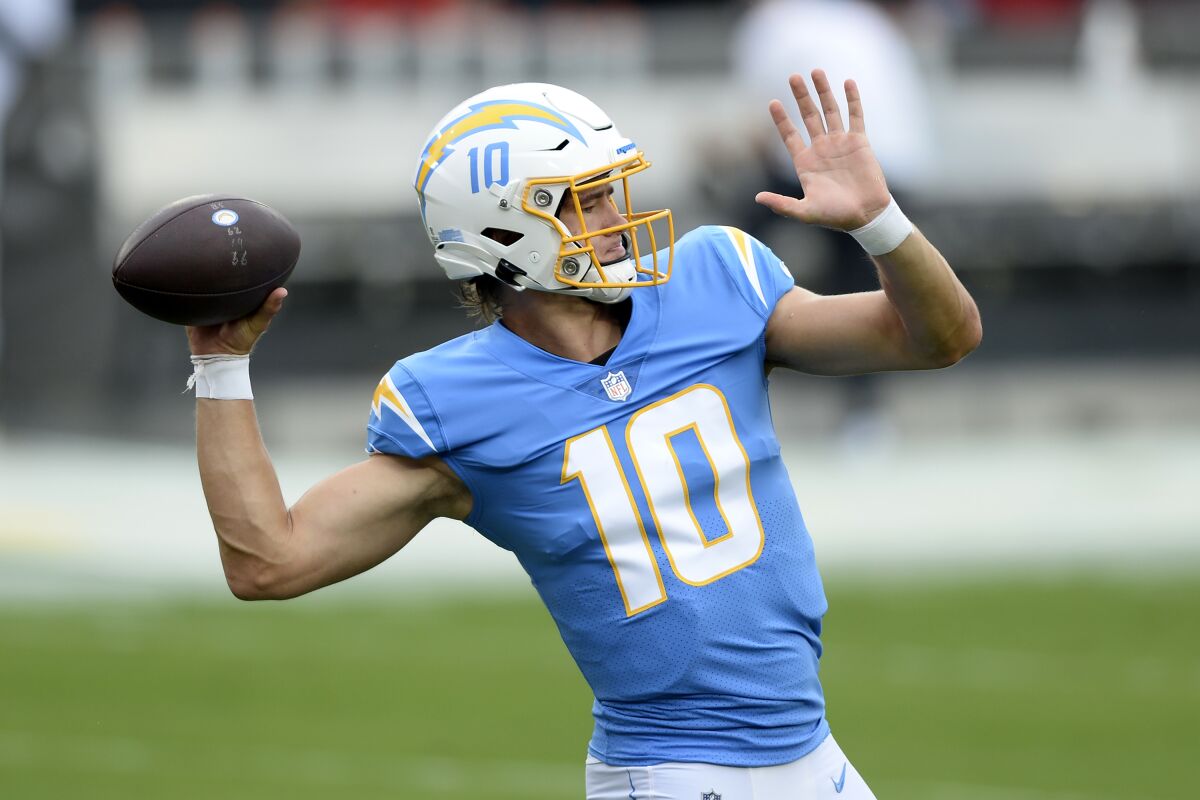Chargers quarterback Justin Herbert throws a pass before a game.