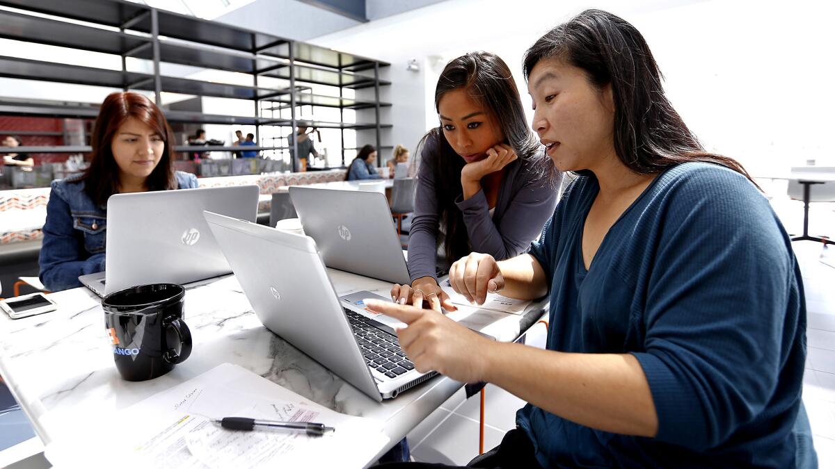 Amy Garcia, left, Leslie Chen and Waisze Lam work at Rotten Tomatoes and Fandango offices in Beverly Hills. Rotten Tomatoes continues to grow under the Fandango corporate umbrella. (Al Seib / Los Angeles Times)