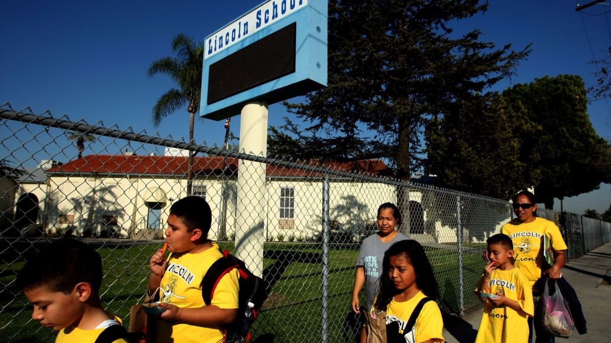 For years, Paramount residents have complained of burning, metallic odors, saying authorities have failed to take sufficient action to protect nearby homes and schools. Above, students and parents walk home from Lincoln Elementary School in Paramount in 2014.