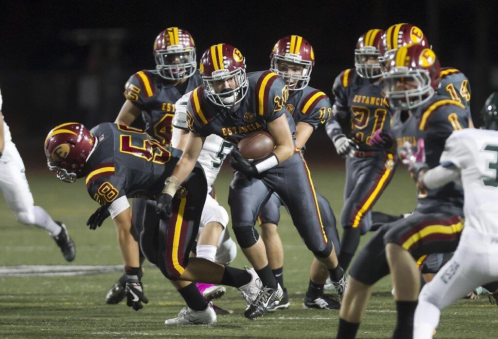 Estancia High's Tyler Ross runs back the opening kickoff for a touchdown against rival Costa Mesa during the Battle for the Bell on Friday night.