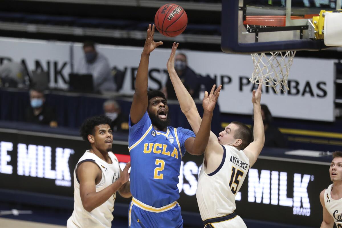 UCLA forward Cody Riley shoots against California forward Grant Anticevich during the first half.