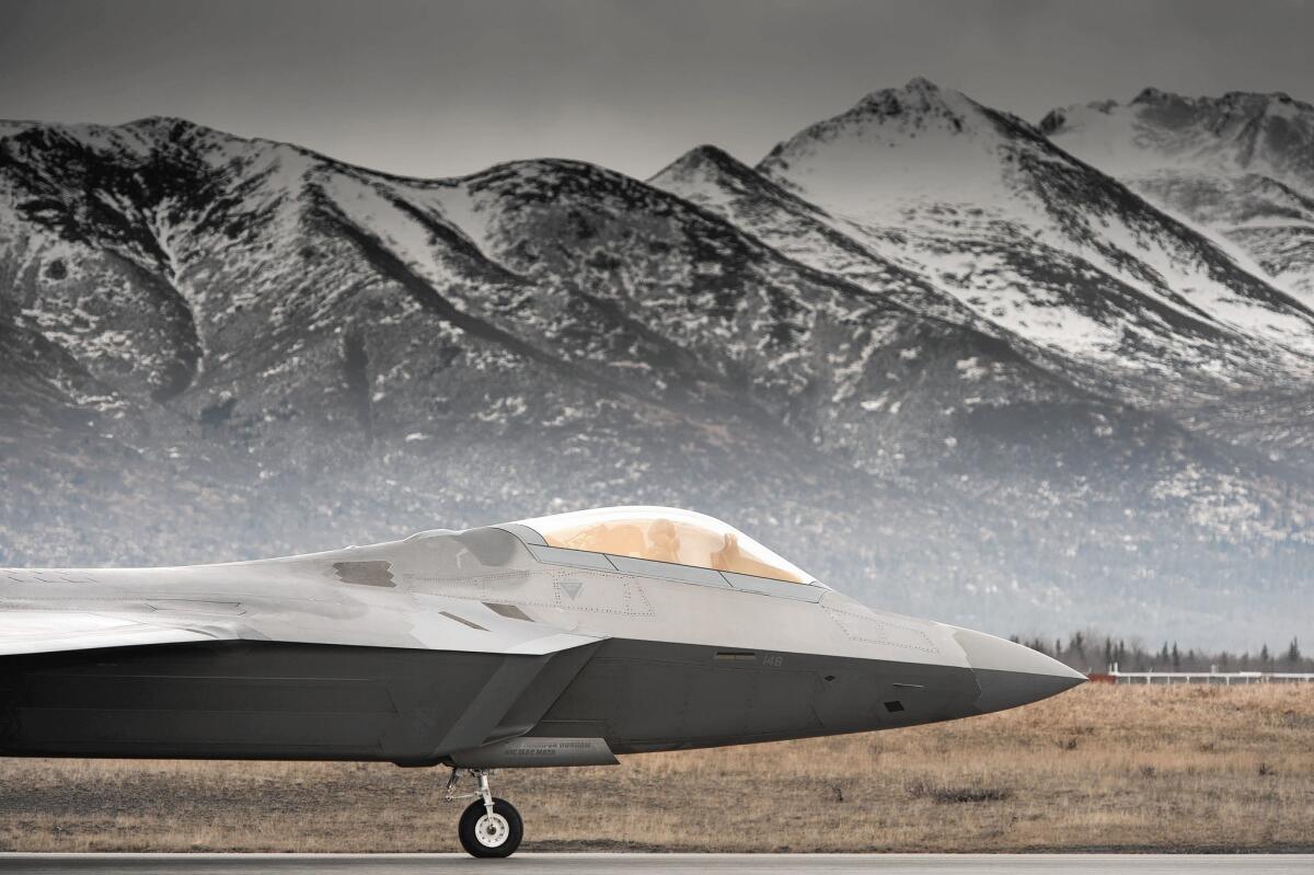 With Alaska's Chugach Mountains as a backdrop, an F-22 taxis on the runway. F-22s are used to monitor Russian aircraft.