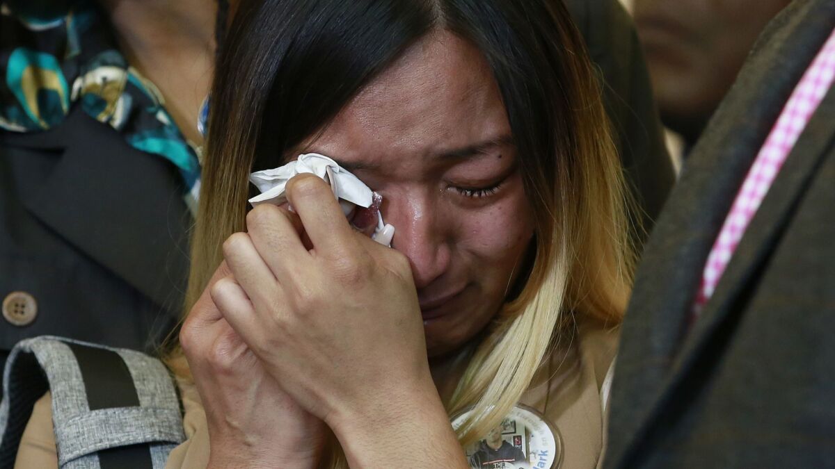 Salena Manni, the fiancee of shooting victim Stephon Clark, wipes tears during a Sacramento news conference Monday. The California Department of Justice will oversee the investigation into Clark's killing.