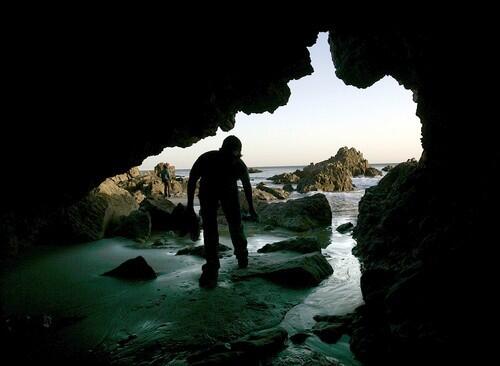 Greg Wood 25, of Northridge, CA enters a cave on the beach at Leo Carillo State Park in Malibu which offers camping and beach access.