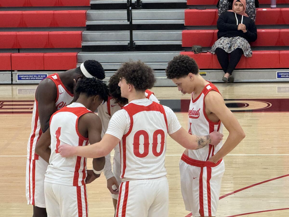 Cleveland's starting five huddles on the court before a game against El Camino Real.