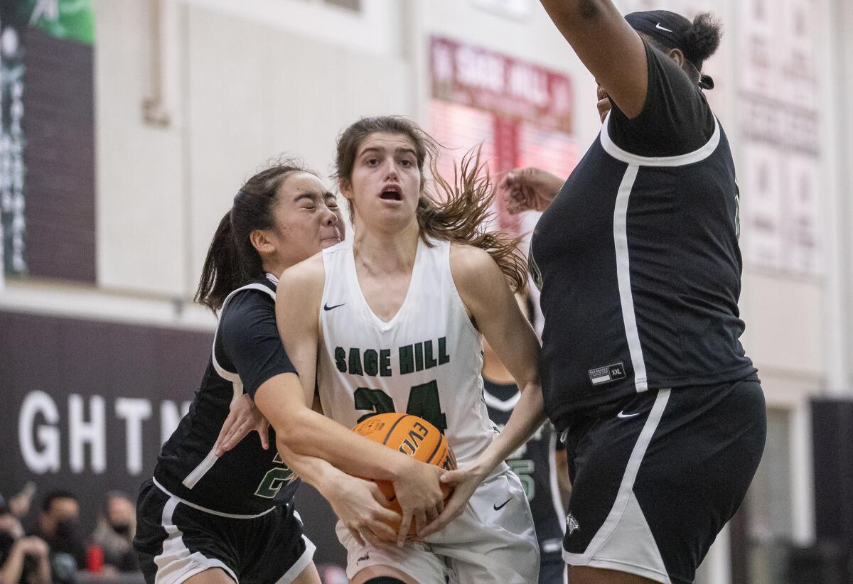 Sage Hill's Isabel Gomez faces pressure from Fairmont Prep defenders Maile Oshita, left, and Siyanda Salter.