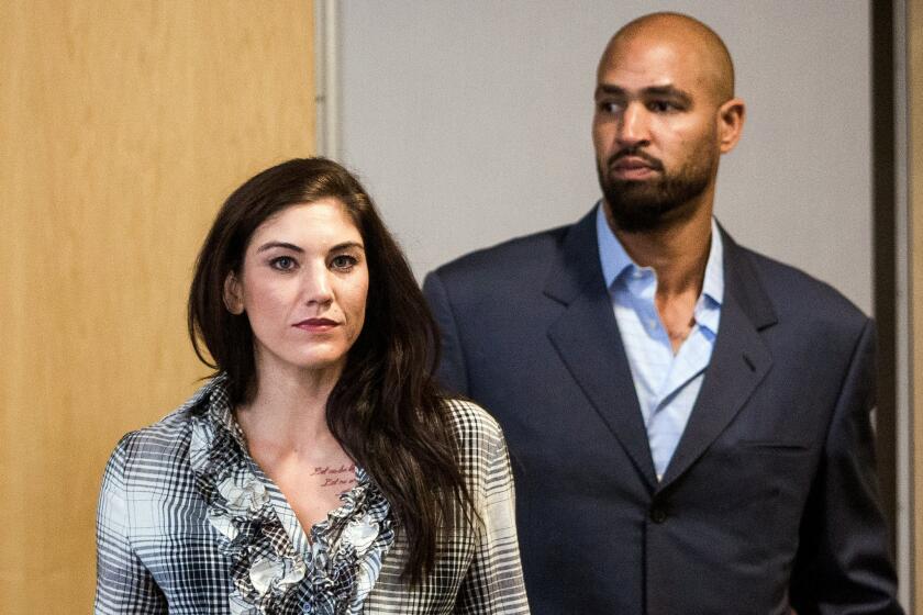 U.S. women's soccer star Hope Solo, left, and her husband, former Seattle Seahawks football player Jerramy Stevens, leave court in Kirkland, Wash., in November.