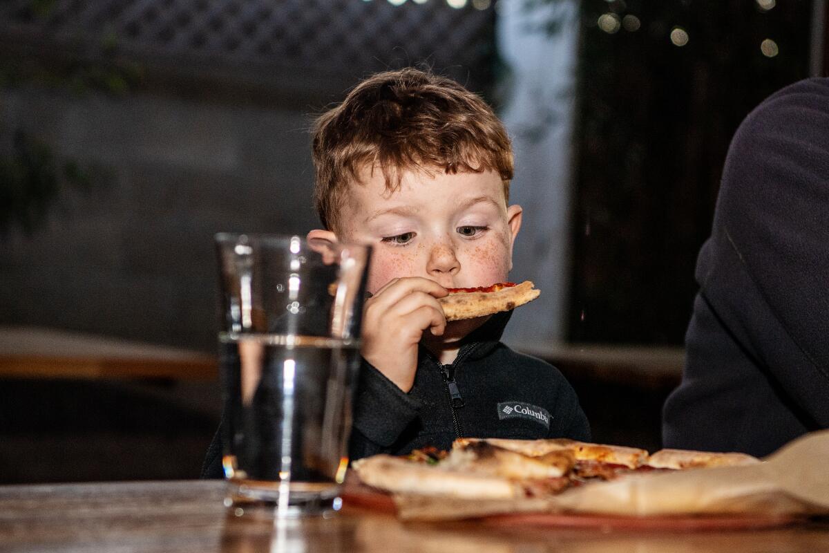 Four-year-old Elliott Woodruff  looks at his slice at Piencone Pizzeria Creamery & Pub.