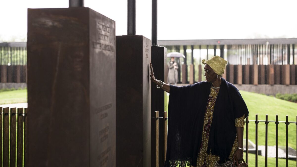 Wretha Hudson, 73, discovers a marker commemorating lynchings in Lee County, Texas, while visiting the National Memorial for Peace and Justice in Montgomery, Ala.
