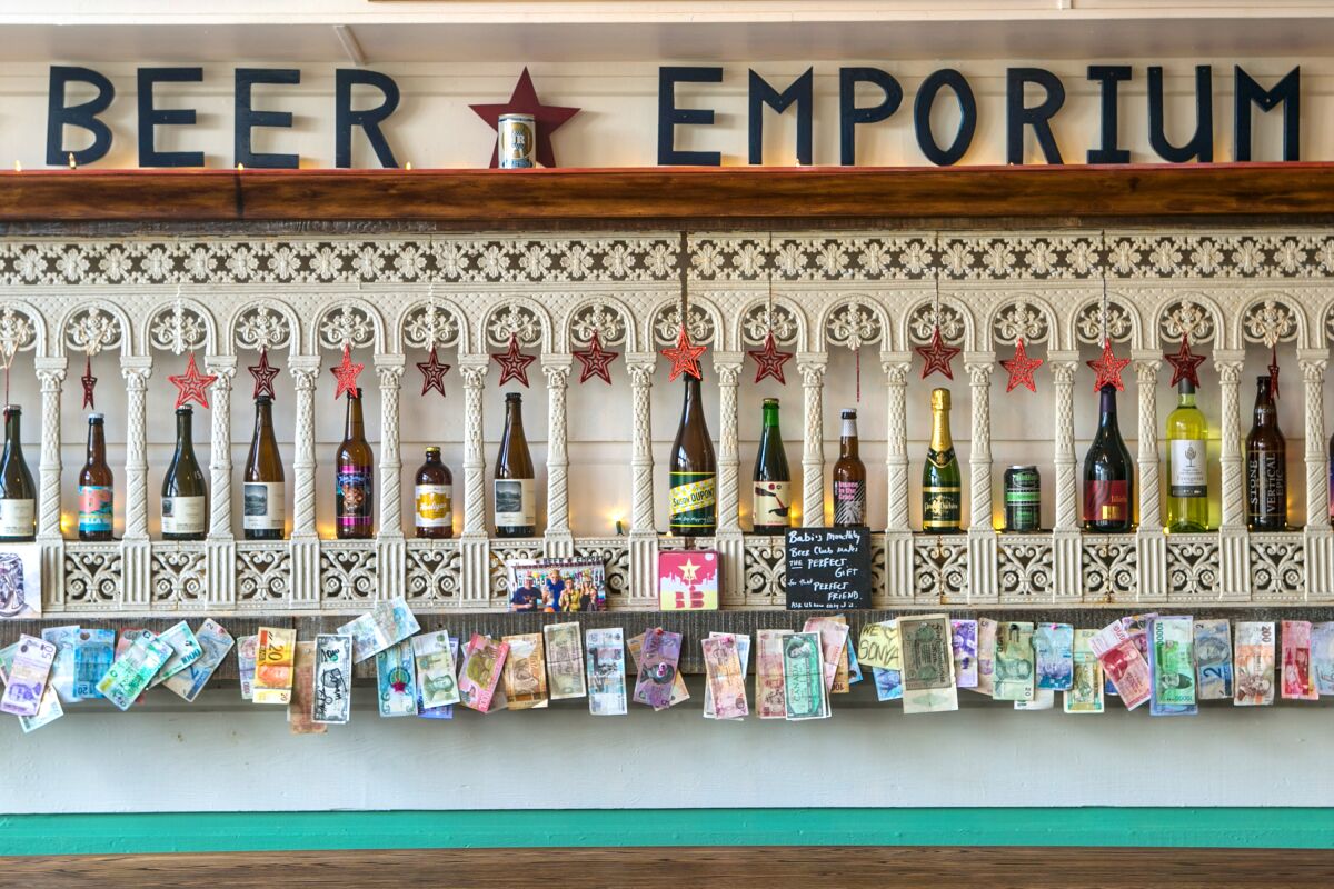 Bottles of beer are shown in a decorative display under a sign that says "Beer Emporium."