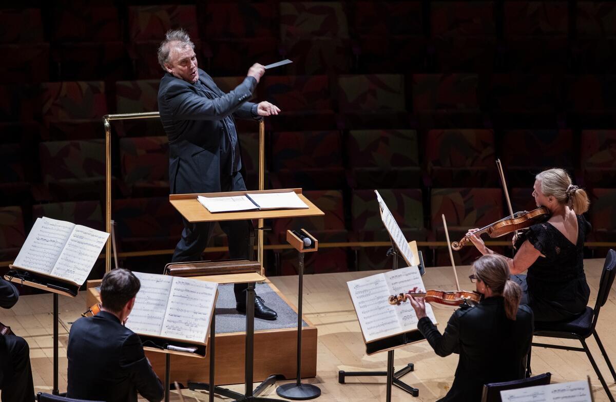 Conductor Jaime Martin exuberantly waves a baton as he conducts the Los Angeles Chamber Orchestra