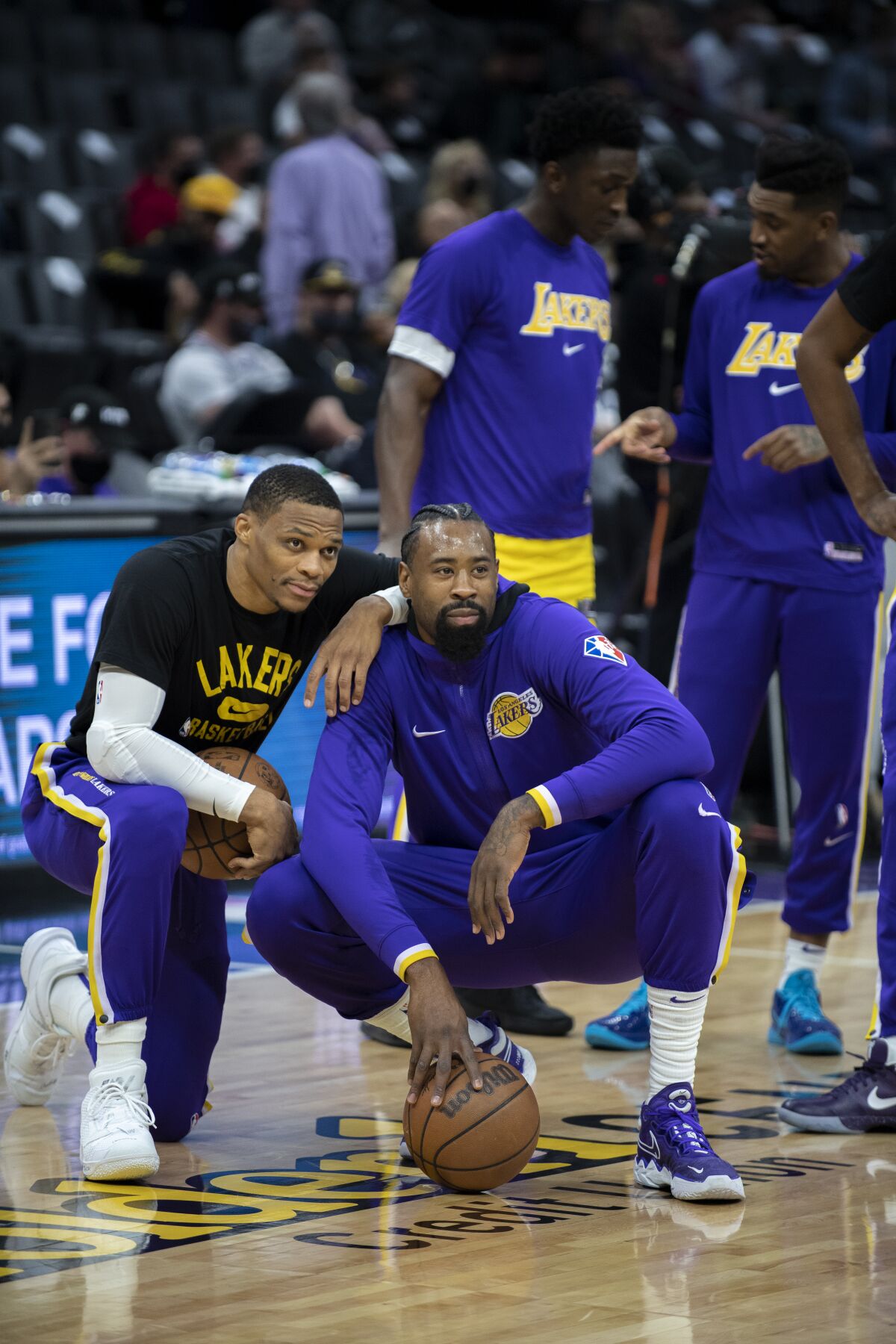 Lakers guard Russell Westbrook and center DeAndre Jordan huddle before the Kings game.
