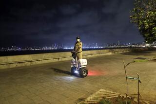 A security officer in Mumbai, India, patrols Marine Drive, which was empty because of coronavirus restrictions.