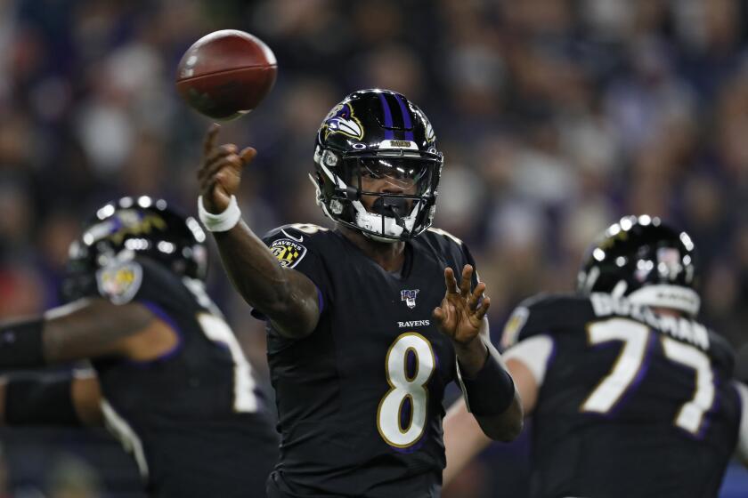 BALTIMORE, MARYLAND - NOVEMBER 03: Quarterback Lamar Jackson #8 of the Baltimore Ravens looks to pass against the New England Patriots during the first quarter at M&T Bank Stadium on November 3, 2019 in Baltimore, Maryland. (Photo by Scott Taetsch/Getty Images)