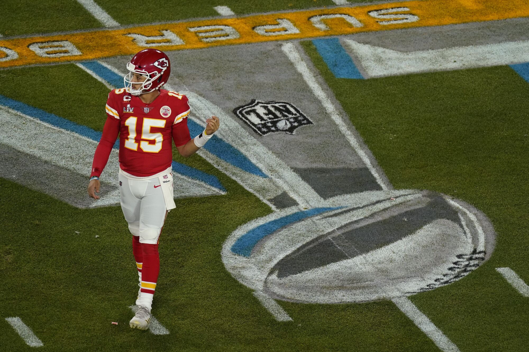 Kansas City Chiefs quarterback Patrick Mahomes walks to the huddle during the first quarter of Super Bowl LV.