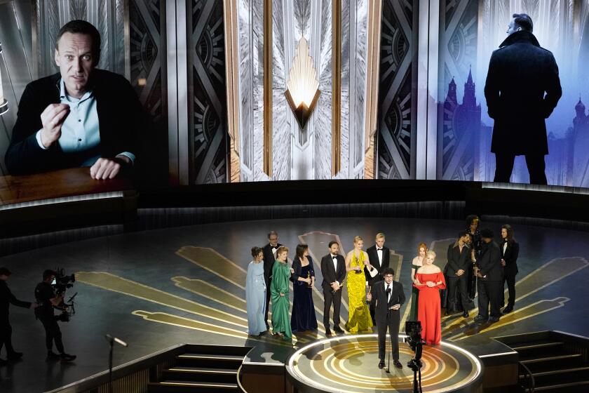 Daniel Roher and the members of the crew from "Navalny" accept the award for best documentary feature film at the Oscars on Sunday, March 12, 2023, at the Dolby Theatre in Los Angeles. (AP Photo/Chris Pizzello)