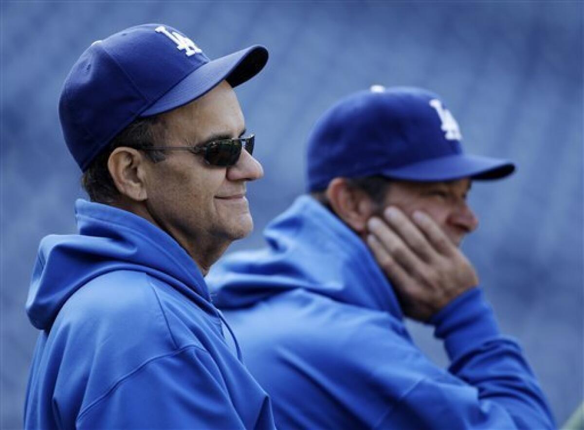 Los Angeles Dodgers manager Don Mattingly (second right) stands on