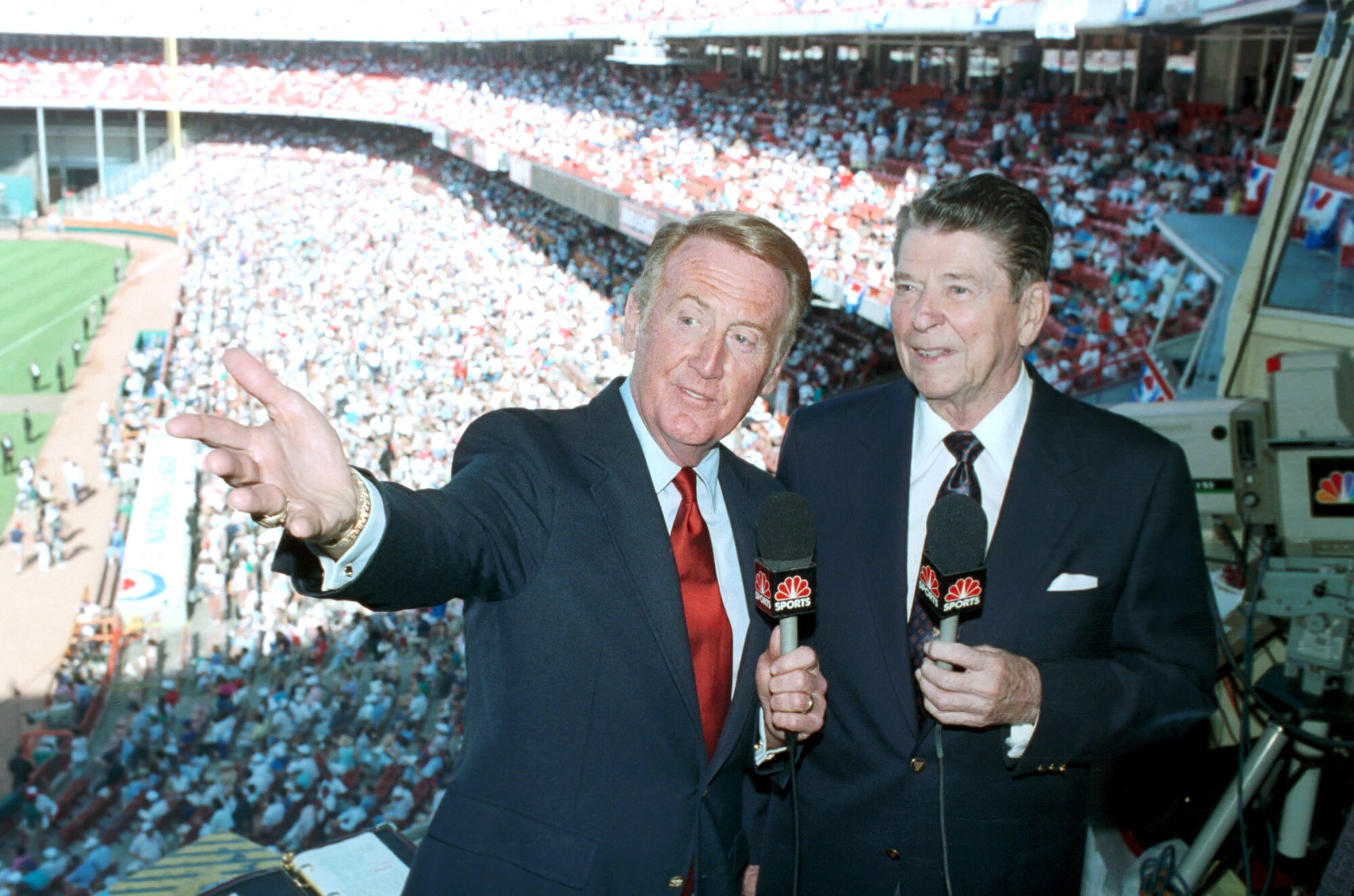 Former President Ronald Reagan joins Vin Scully in the announcers booth at Anaheim Stadium.