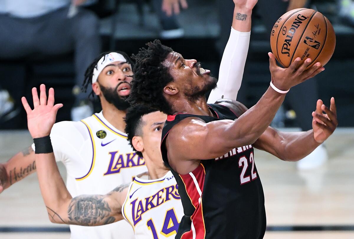 Miami's Jimmy Butler scores on a layup against Lakers guard Danny Green during the fourth quarter of Game 3 on Sunday.