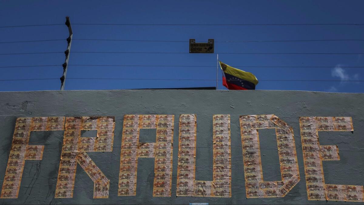 A sign in Caracas uses bank notes to spell out fraud as Venezuela is asked to vote Sunday to elect an assembly to rewrite the Venezuelan constitution.