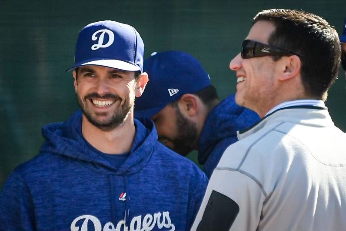Dodgers general manager Brandon Gomes, left, talks with Andrew Friedman, the Dodgers' president of operations.