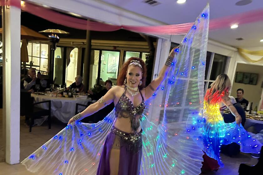 Performers with Rachel Belly Dance show their colors.