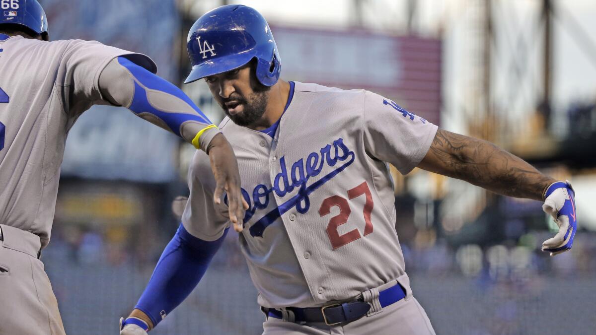 Dodgers right fielder Matt Kemp, right, celebrates with teammate Yasiel Puig after hitting a two-run home run during the first inning of an 11-3 win over the Colorado Rockies on Monday.