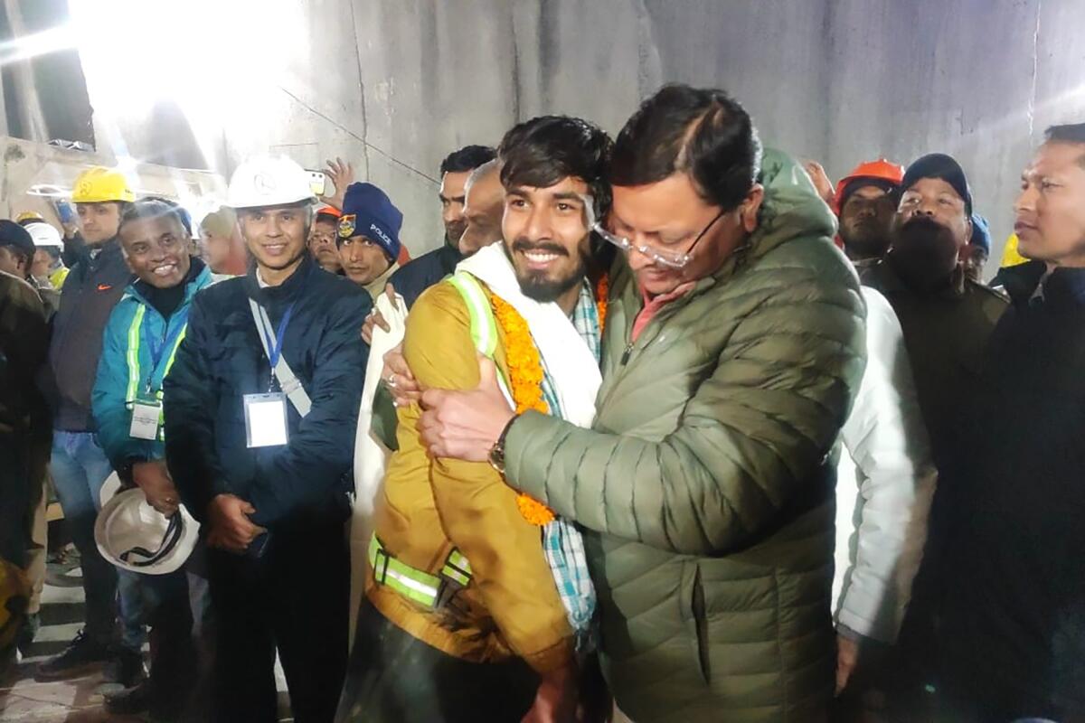 A state official hugs a smiling rescued worker.
