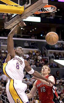 MAKING A POINT: Kobe Bryant goes up for a dunk against Toronto's Matt Bonner