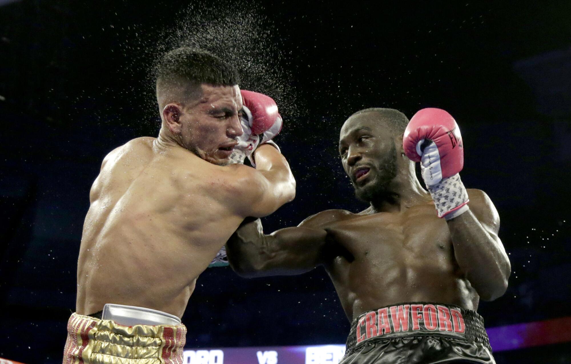 Terence Crawford connects with Jose Benavidez during their WBO welterweight title boxing bout in 2018