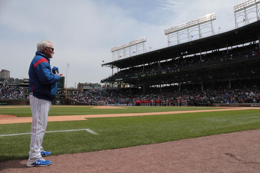 Cubs manager Joe Maddon stands during the national anthem at Wrigley Field, Friday, May 3, 2019.