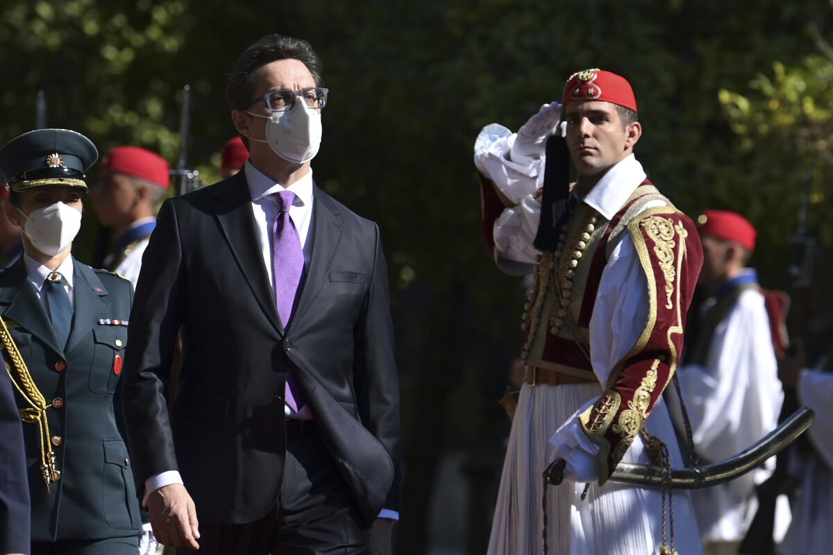 North Macedonian President Stevo Pendarovski reviews the Greek presidential guard before their meeting as part of Pendarovski's two-day official visit to Greece, in Athens, Tuesday, Oct. 5, 2021. (Aris Messinis/Pool via AP)